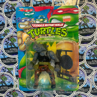 TMNT- Vintage 1992 Playmates “Teenage Mutant Ninja Turtles” Rocksteady Poseable Action Figure [New/Sealed & Unpunched]
