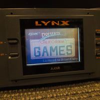 Atari Lynx Model 1 Console With 7 Games, Power Cord, and Screen Cover
